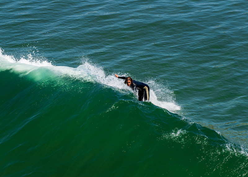 A surfer turning up towards the wave crest. 